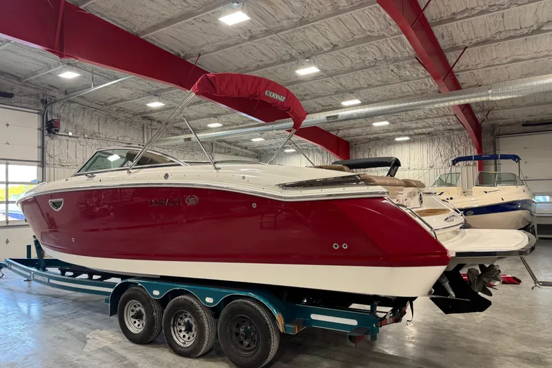Slide: The Image of 2011 Cobalt 296 boat with red and white exterior in a storage facility. - 4