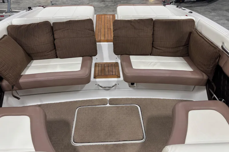 Slide: The Image of Interior of a 2011 Cobalt 296 boat with cushioned seating and carpeted flooring. - 7