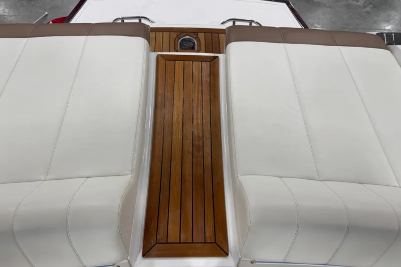 Slide: The Image of Cobalt 296 boat interior, 2011 model, featuring white leather seats and wooden deck. - 8