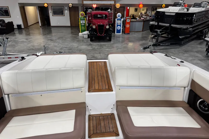 Slide: The Image of Interior of a 2011 Cobalt 296 boat with white and brown seating, wooden accents. - 9