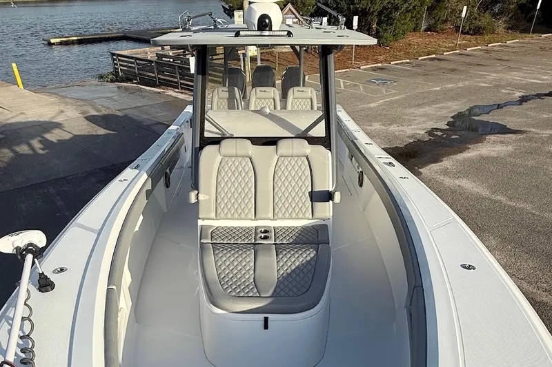 Slide: The Image of 2024 Front Runner 39 Center Console boat at dock, featuring sleek design and comfortable seating. - 14