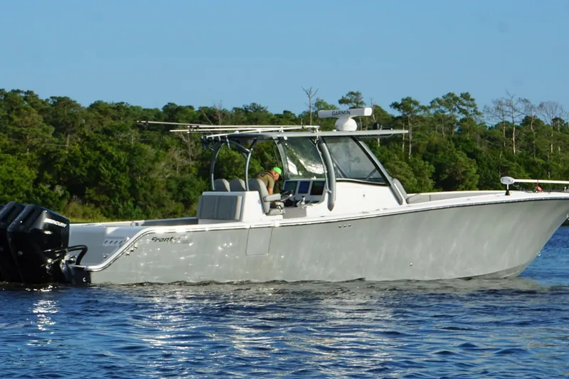 Slide: The Image of 2024 Front Runner 39 Center Console boat cruising on a lake with forested background. - 9