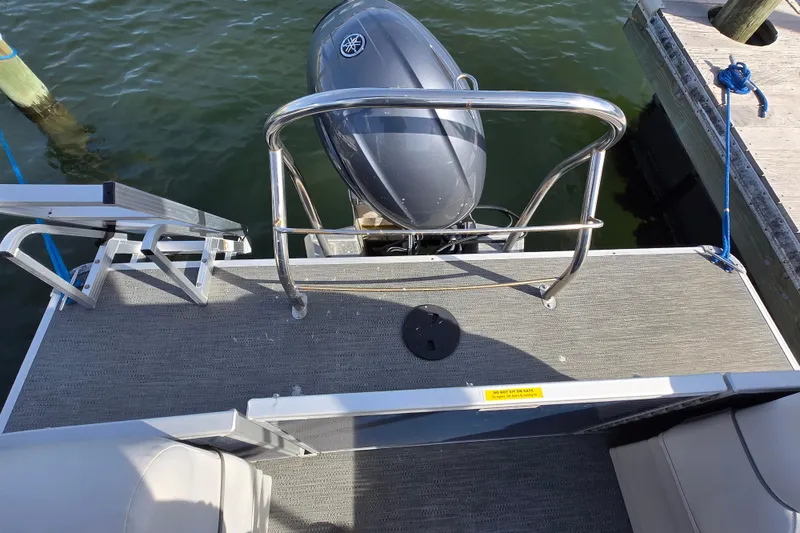 Slide: The Image of 2023 Godfrey Sweetwater 2286 SBX pontoon boat with blue cover docked at marina. - 12