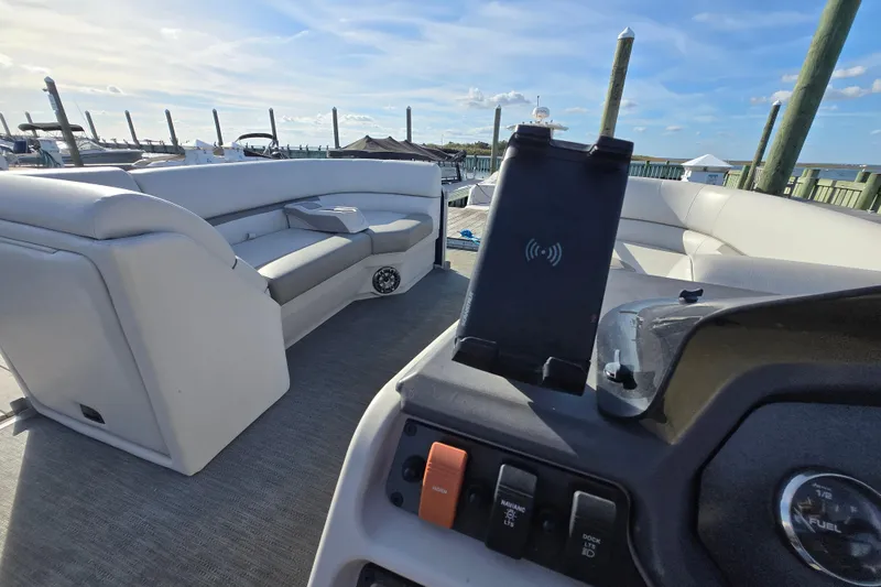 Slide: The Image of 2023 Godfrey Sweetwater 2286 SBX with Garmin device, docked under clear skies. - 19