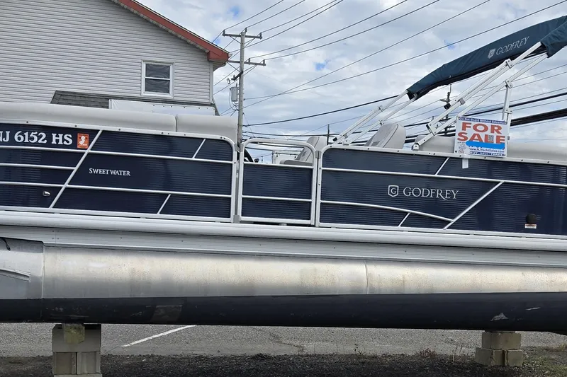 Slide: The Image of 2023 Godfrey Sweetwater 2286 SBX pontoon boat for sale, displayed outdoors. - 23