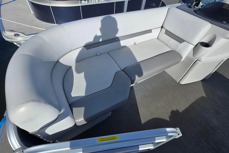 Slide: The Image of 2023 Godfrey Sweetwater 2286 SBX boat with comfortable gray seating and cup holder. - 6