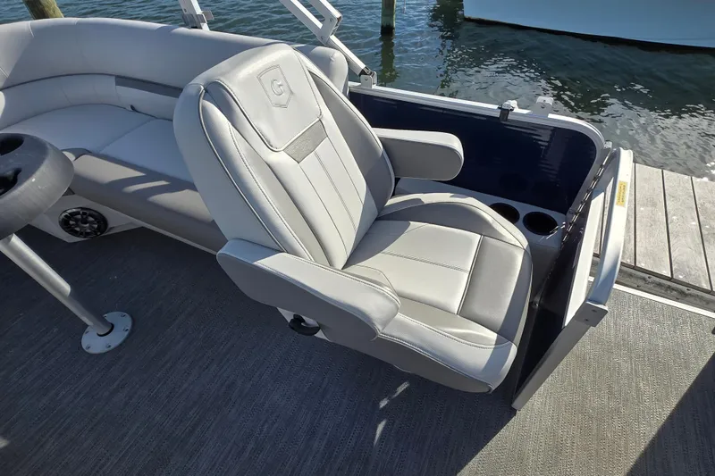 Slide: The Image of 2023 Godfrey Sweetwater 2286 SBX boat interior with steering wheel and captain's chair. - 8