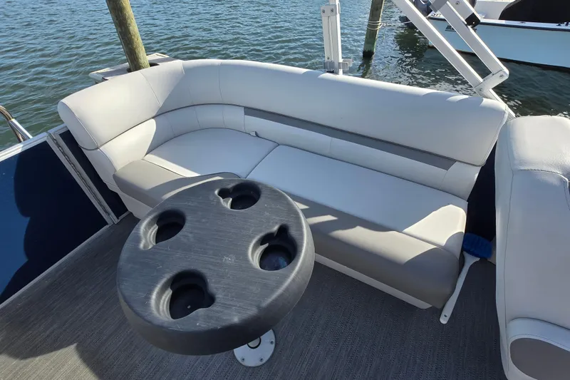 Slide: The Image of Captain's chair on 2023 Godfrey Sweetwater 2286 SBX pontoon boat, docked by water. - 9
