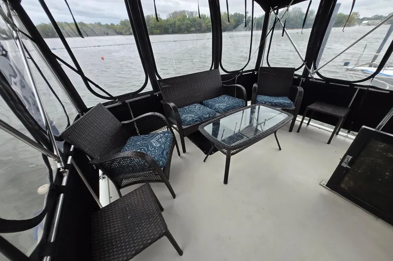 Slide: The Image of 1988 Mainship 36 Double Cabin with wicker seating and glass table on deck. - 15
