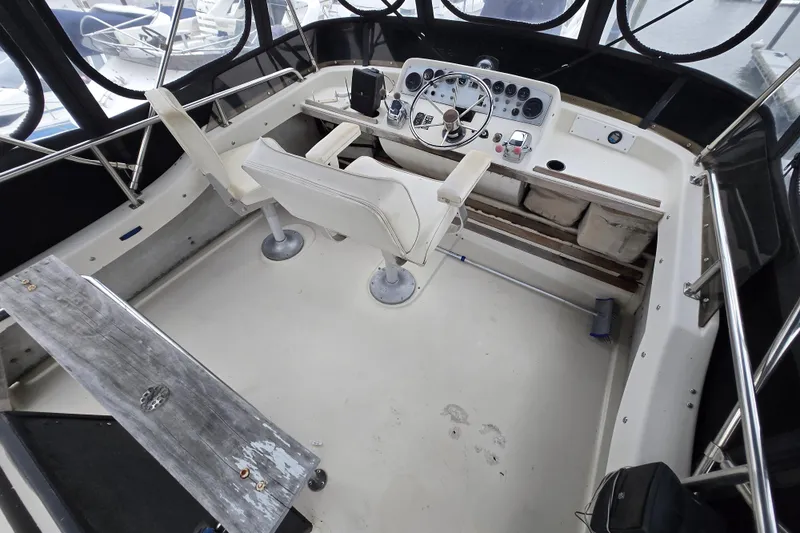 Slide: The Image of 1988 Mainship 36 Double Cabin helm with dual seats and control panel. - 18