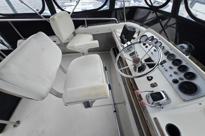 Slide: The Image of 1988 Mainship 36 Double Cabin helm with steering wheel and control panel. - 19