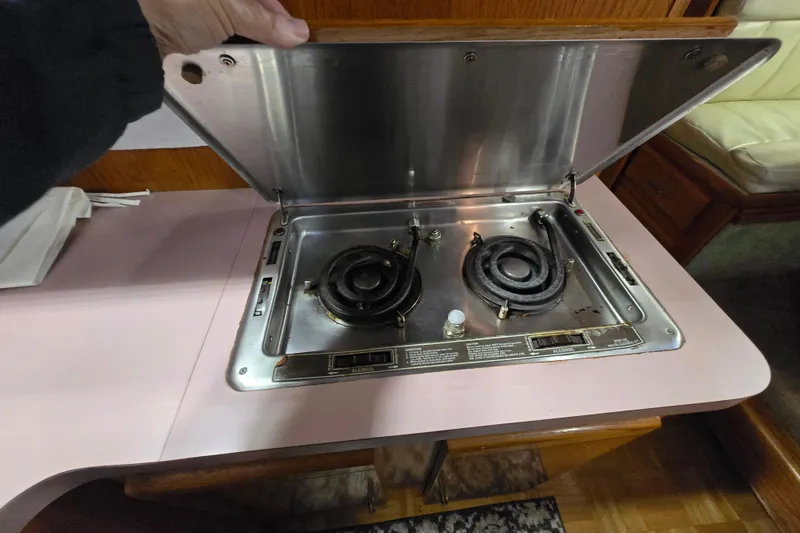 Slide: The Image of 1988 Mainship 36 Double Cabin stove with two burners and stainless steel cover. - 32