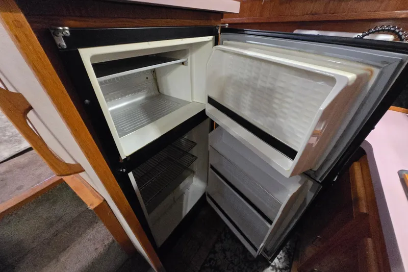 Slide: The Image of Open refrigerator in 1988 Mainship 36 Double Cabin boat kitchen. - 33