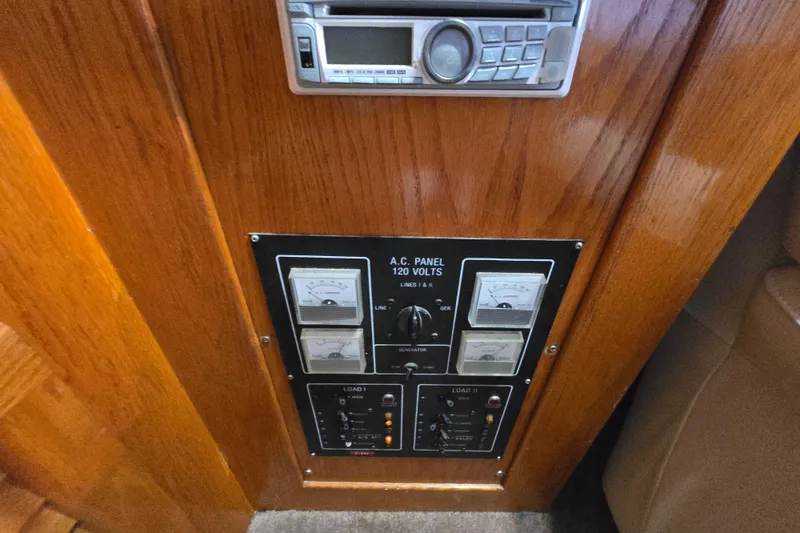 Slide: The Image of 1988 Mainship 36 Double Cabin AC panel with gauges and controls. - 39