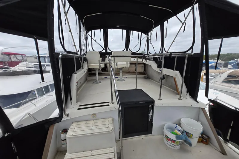 Slide: The Image of 1988 Mainship 36 Double Cabin boat interior with seating and canopy. - 4