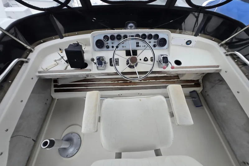 Slide: The Image of 1988 Mainship 36 Double Cabin helm with steering wheel and control panel. - 40
