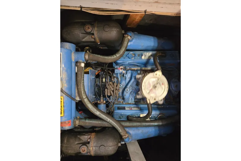 Slide: The Image of 1988 Mainship 36 Double Cabin engine, blue with hoses and components visible. - 44
