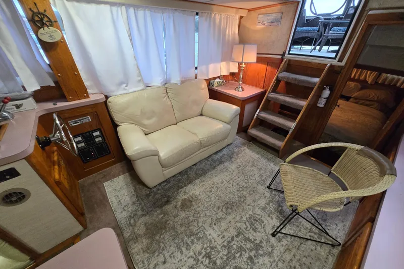 Slide: The Image of Interior of 1988 Mainship 36 Double Cabin with cozy seating and nautical decor. - 6