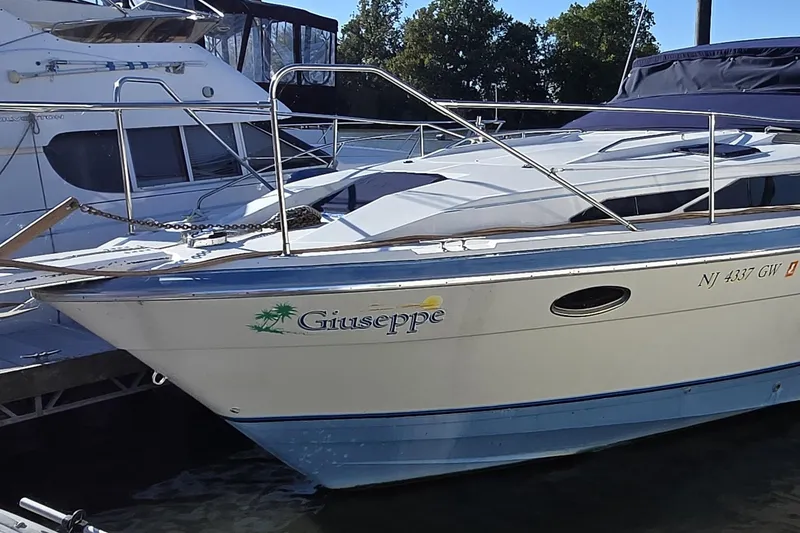 Slide: The Image of 1988 Bayliner 3450 Avanti boat docked with blue canvas cover. - 0