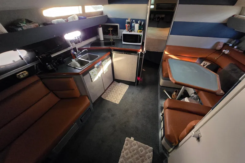 Slide: The Image of 1988 Bayliner 3450 Avanti docked, featuring sleek design and "Giuseppe" name on hull. - 1