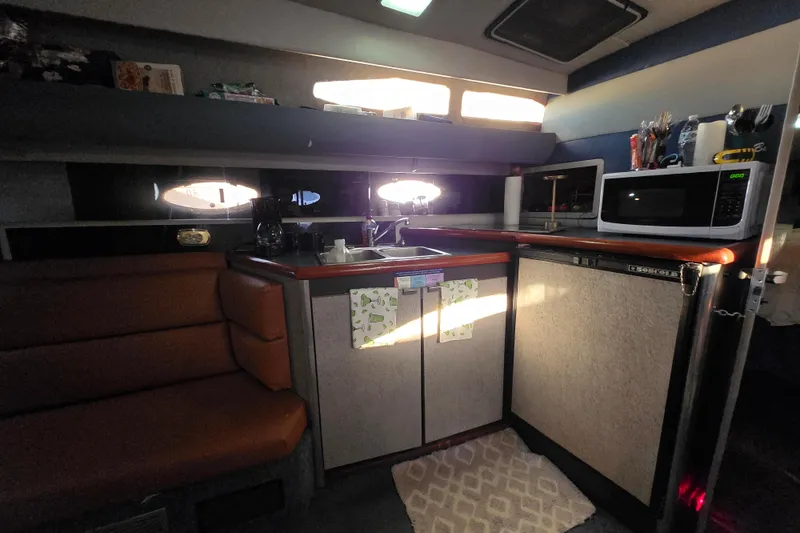 Slide: The Image of 1988 Bayliner 3450 Avanti boat docked, featuring sleek design and sturdy railings. - 10