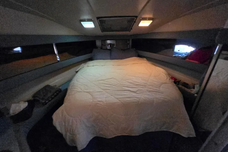 Slide: The Image of 1988 Bayliner 3450 Avanti boat docked with blue cover and ropes. - 11