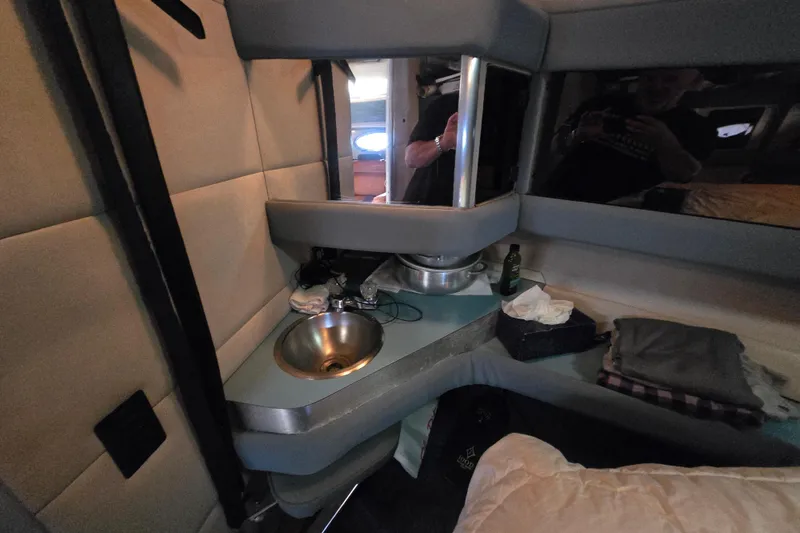 Slide: The Image of Interior of 1988 Bayliner 3450 Avanti boat with kitchenette and seating area. - 12