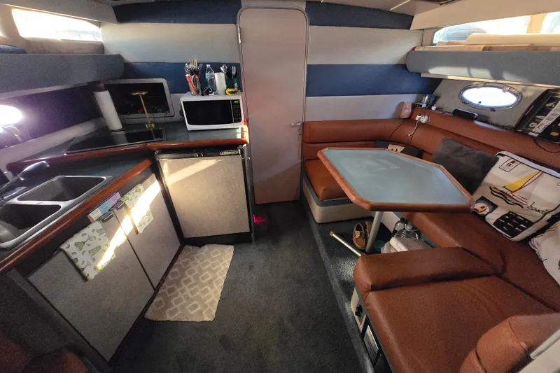 Slide: The Image of Cozy cabin interior of 1988 Bayliner 3450 Avanti with bed and storage. - 15