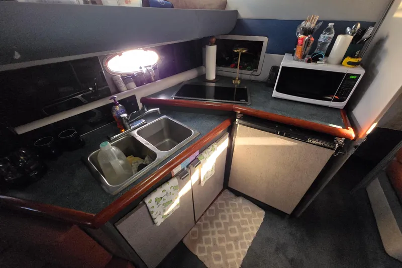 Slide: The Image of Interior of 1988 Bayliner 3450 Avanti with cozy seating and table setup. - 16