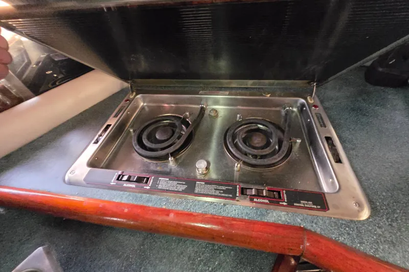 Slide: The Image of 1988 Bayliner 3450 Avanti interior with kitchen, seating area, and modern amenities. - 17