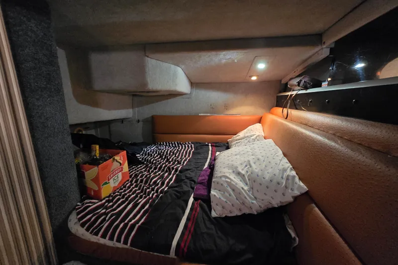 Slide: The Image of 1988 Bayliner 3450 Avanti boat kitchen with sink, microwave, and countertop essentials. - 18