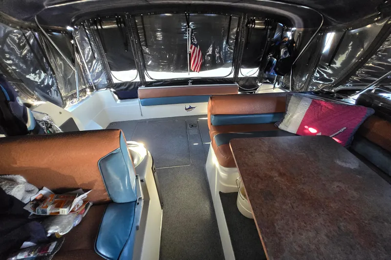 Slide: The Image of Interior of 1988 Bayliner 3450 Avanti yacht with kitchen and seating area. - 2