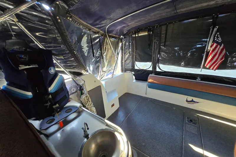 Slide: The Image of 1988 Bayliner 3450 Avanti interior with orange upholstery and blue vent panel. - 26