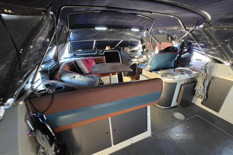 Slide: The Image of 1988 Bayliner 3450 Avanti interior with table, seating, and American flag. - 27