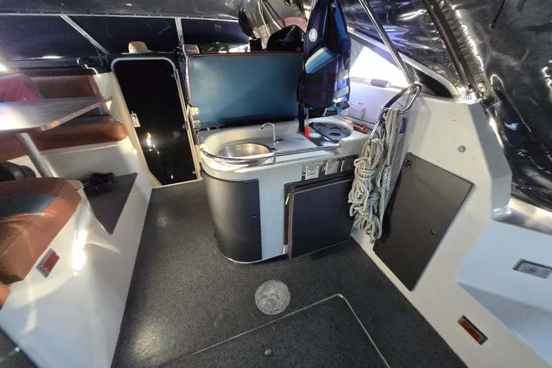 Slide: The Image of 1988 Bayliner 3450 Avanti interior with sink, life jacket, and American flag. - 28