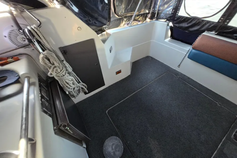 Slide: The Image of Interior of 1988 Bayliner 3450 Avanti boat with seating, table, and helm. - 29