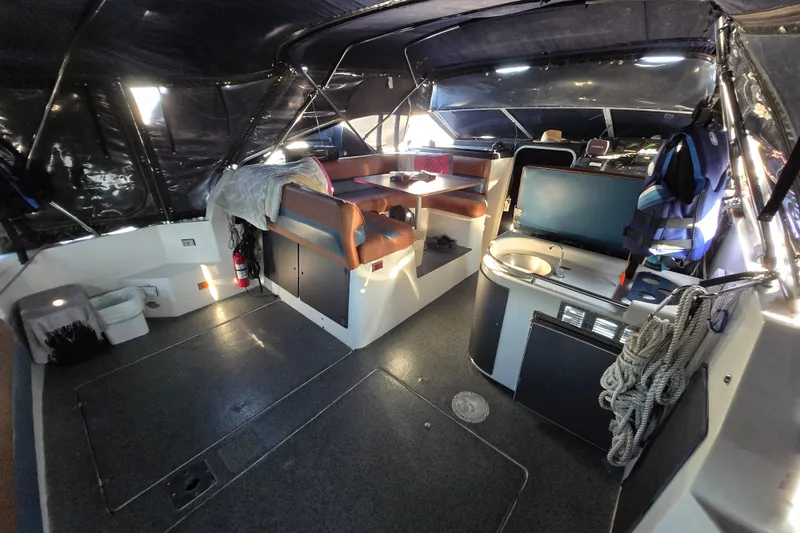 Slide: The Image of Interior of 1988 Bayliner 3450 Avanti boat with seating and table. - 3