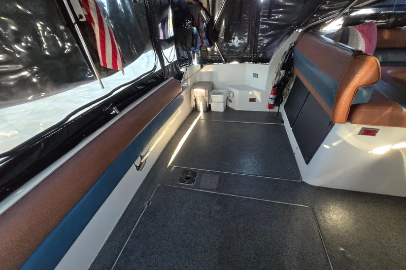 Slide: The Image of 1988 Bayliner 3450 Avanti interior with kitchenette, seating, and nautical equipment. - 30