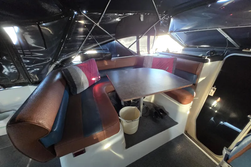 Slide: The Image of 1988 Bayliner 3450 Avanti interior with ropes, carpeted floor, and seating area. - 31