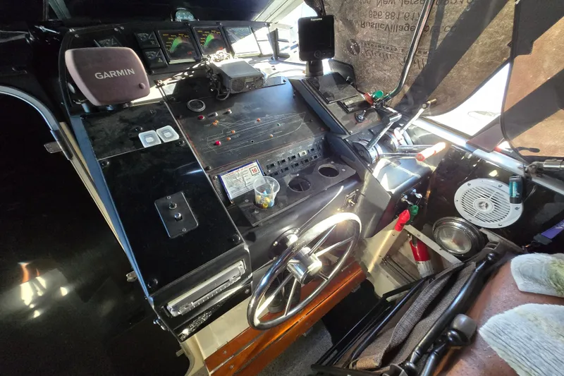 Slide: The Image of 1988 Bayliner 3450 Avanti interior with seating, American flag, and fire extinguisher. - 32