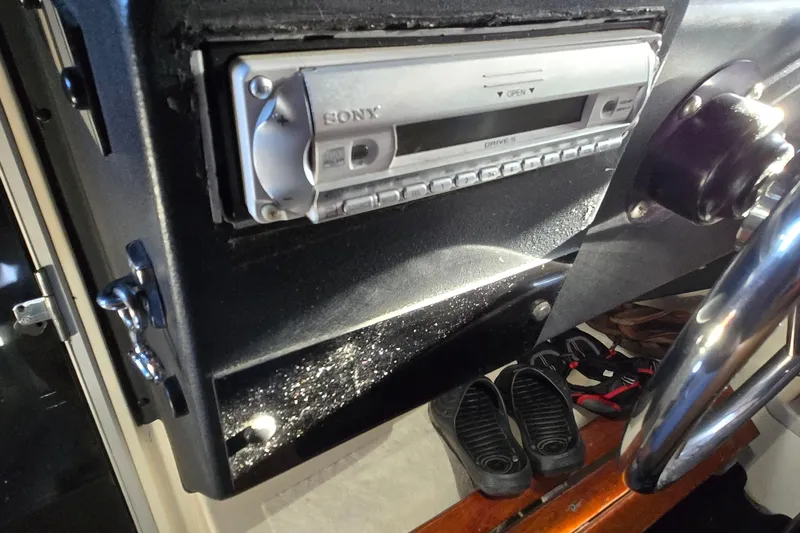Slide: The Image of Control panel of a 1988 Bayliner 3450 Avanti boat, featuring throttle levers and navigation equipment. - 36