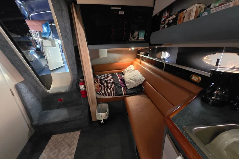 Slide: The Image of Interior of 1988 Bayliner 3450 Avanti boat with seating and kitchenette. - 4