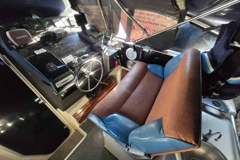 Slide: The Image of Control panel of a 1988 Bayliner 3450 Avanti boat with switches and levers. - 42