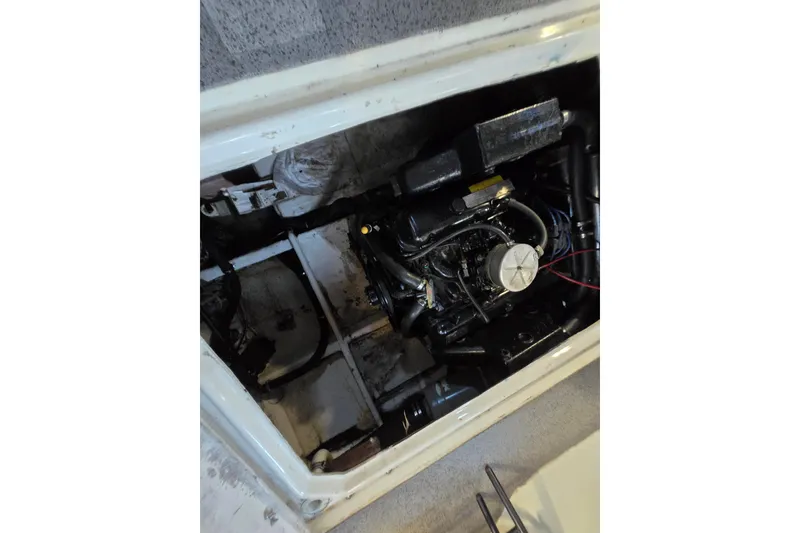 Slide: The Image of 1988 Bayliner 3450 Avanti interior with brown and blue seating, steering wheel, and fire extinguisher. - 43