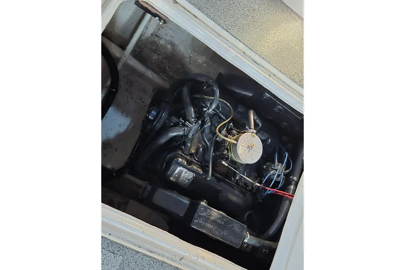 Slide: The Image of 1988 Bayliner 3450 Avanti helm with steering wheel, controls, and brown leather seat. - 44