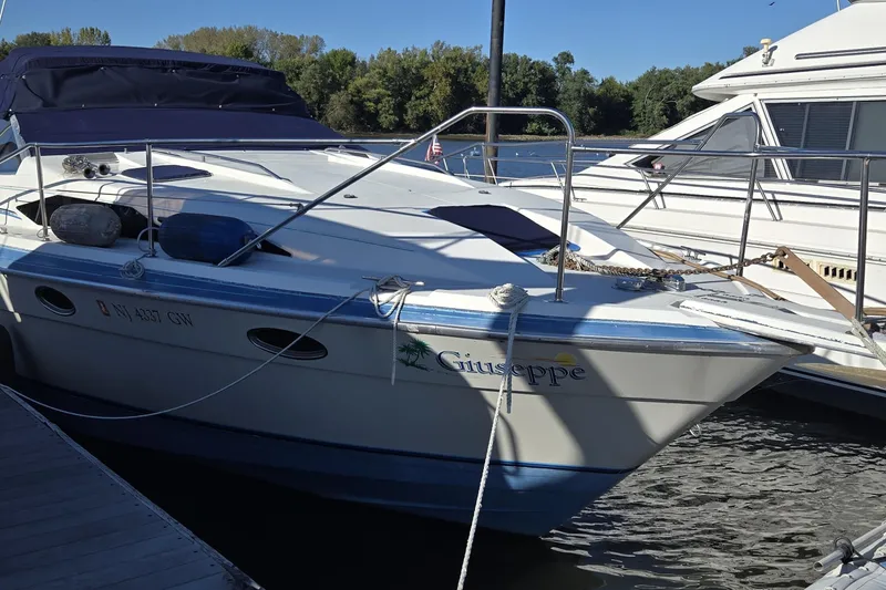 Slide: The Image of 1988 Bayliner 3450 Avanti cabin interior with seating, bed, and kitchenette. - 5