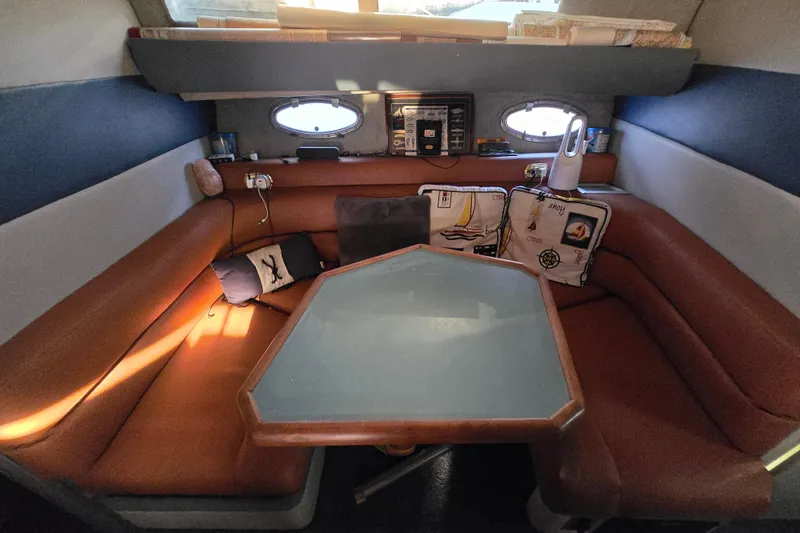 Slide: The Image of 1988 Bayliner 3450 Avanti cabin interior with cozy seating and table setup. - 7