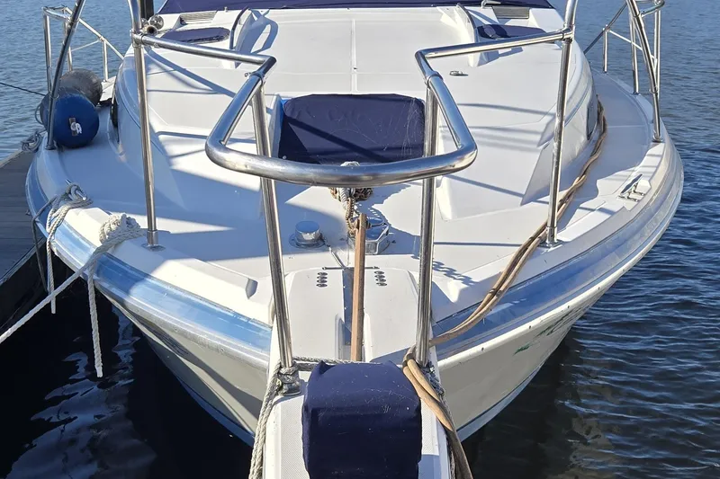 Slide: The Image of 1988 Bayliner 3450 Avanti cabin interior with brown seating and a glass-top table. - 8