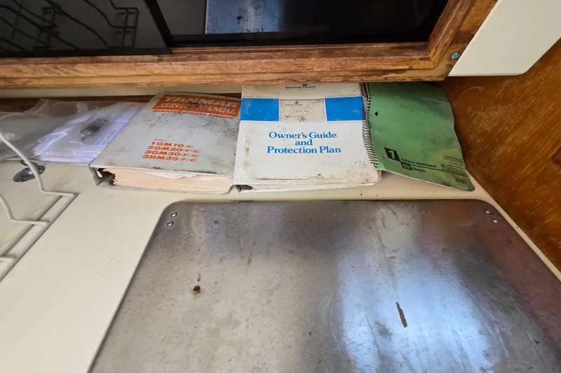 Slide: The Image of Manuals and notebooks on a Pearson 303 Sloop, 1986, cabin shelf. - 15