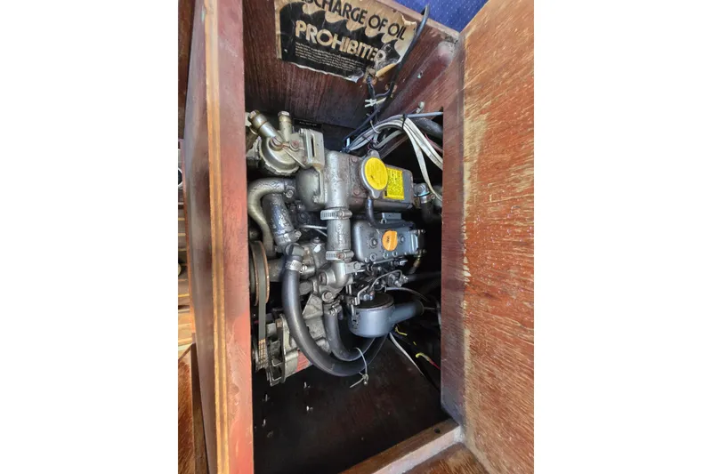 Slide: The Image of Engine compartment of a 1986 Pearson 303 Sloop sailboat, showcasing mechanical components. - 26